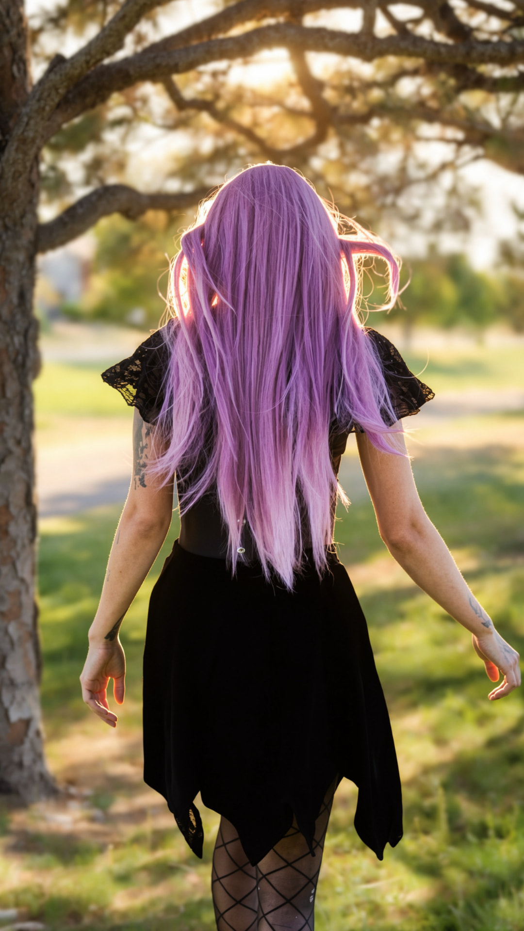 Purple-haired woman in black lace among trees from The Eclipse session