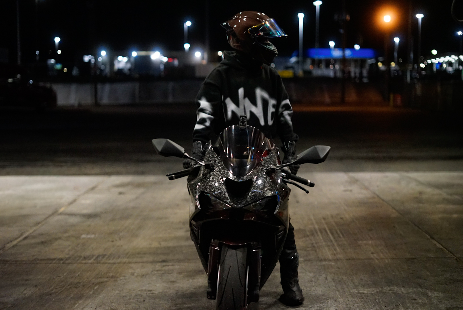 Motorcyclist in NNT hoodie at night from The Nocturne session
